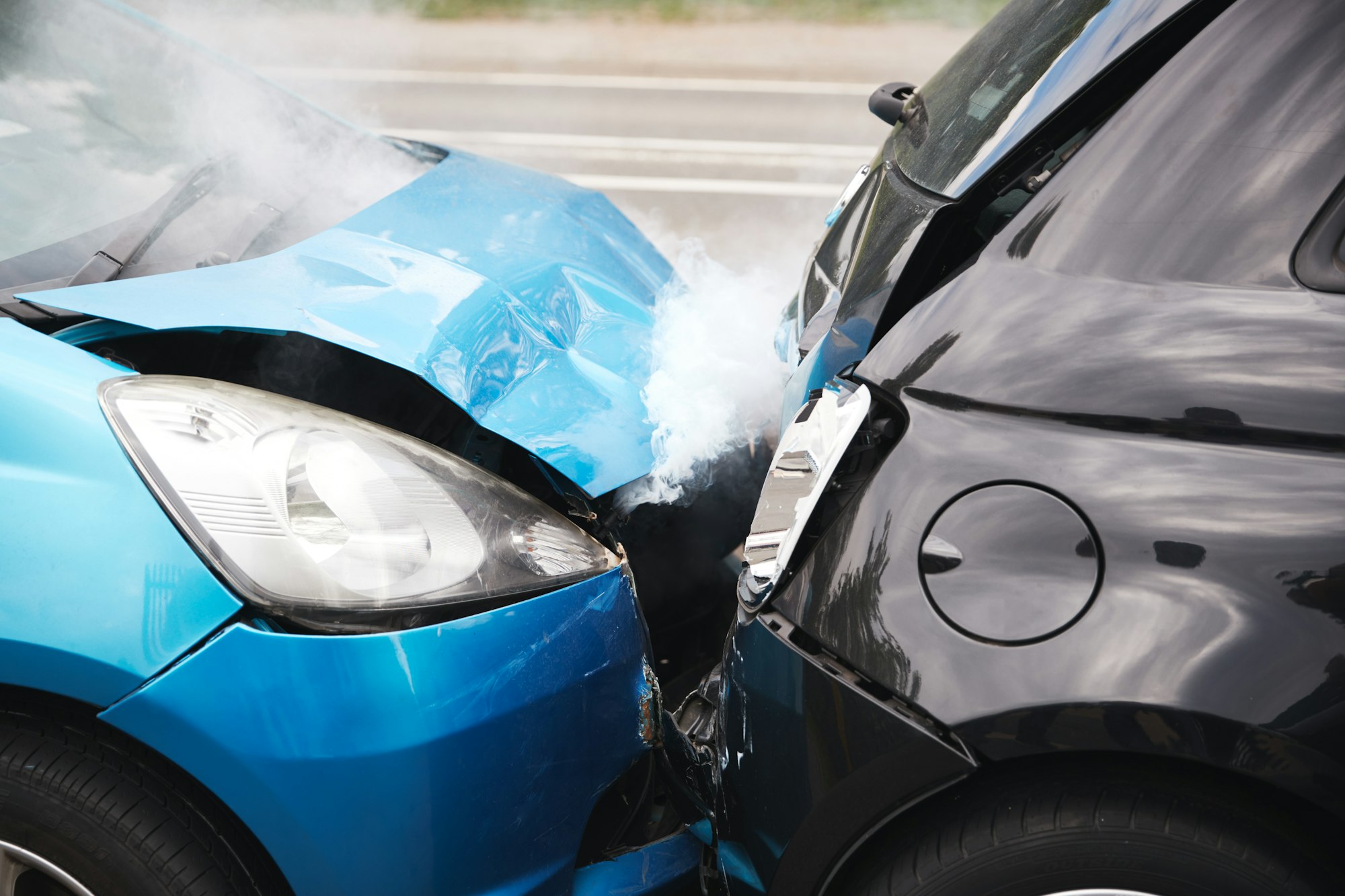 Close Up Of Two Cars Damaged In Road Traffic Accident