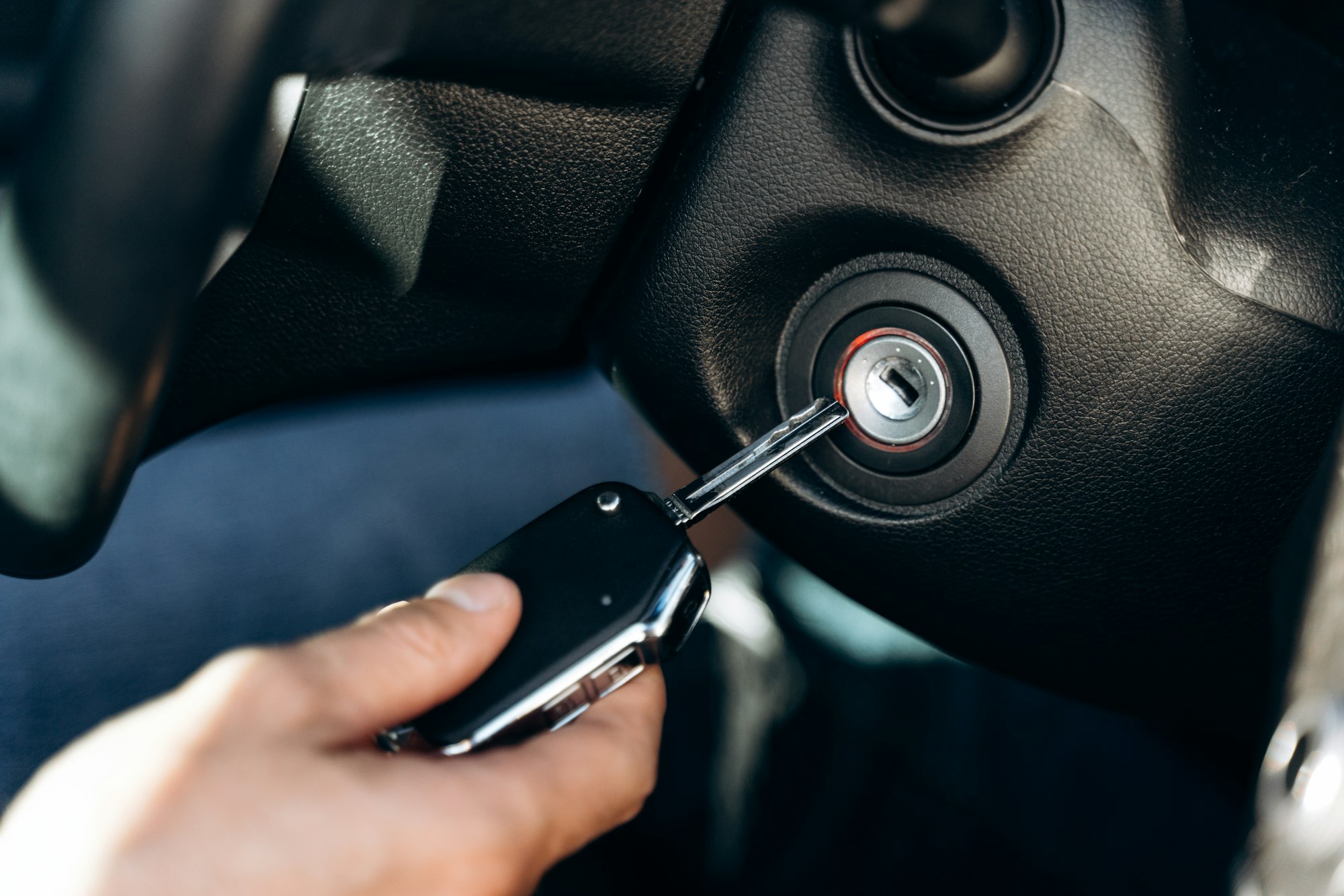 Selective focus of the male hand winds up the car ignition key